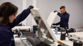 Two people using scanning machines.